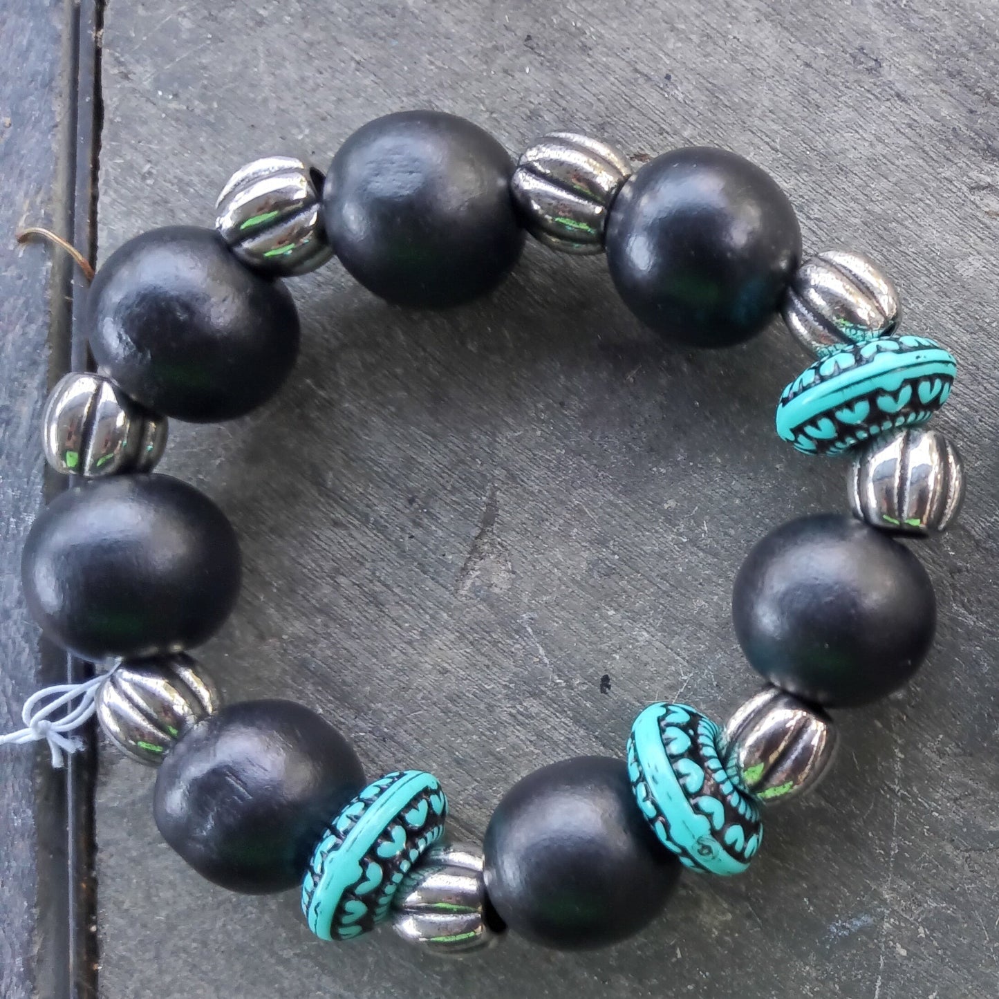 One large black beaded bracelet with silver and turquoise accents  beads.