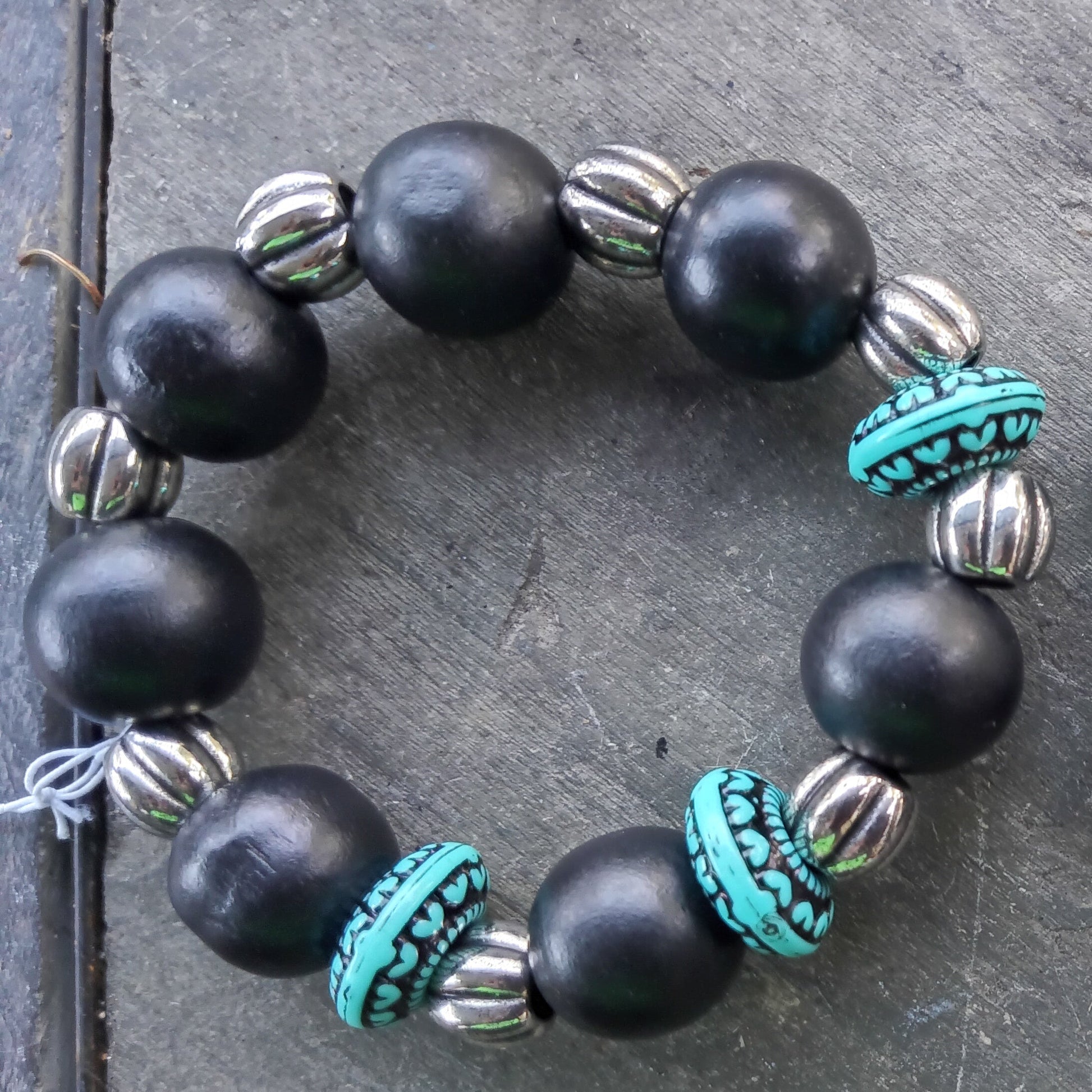 One large black beaded bracelet with silver and turquoise accents  beads.