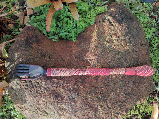 Vintage hand-shaped back scratcher featuring a decorated wooden handle.